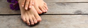 Beauchamp Foot Care - beautiful feet and hands against wood floor