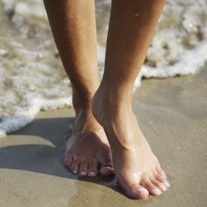 Woman's feet on water's edge