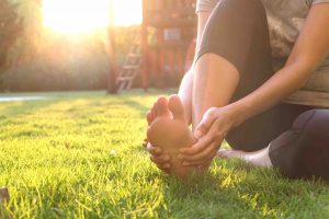Woman holding sore foot