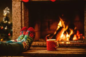 Feet by fireplace